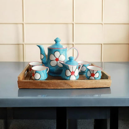 WOOD CURLS rectangular mango wood serving tray holding a blue floral ceramic tea set on a grey table