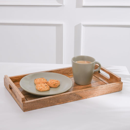 WOOD CURLS rectangular mango wood serving tray with handles holding a ceramic plate of cookies and a coffee mug