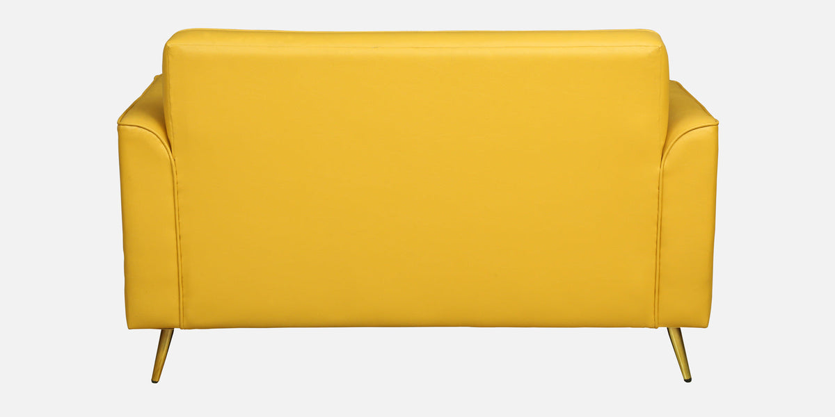 WOOD CURLS Aurelia mustard leatherette two-seater sofa back view with elegant golden metal legs
