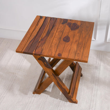 WOOD CURLS Nova square coffee table in natural Sheesham wood with a slatted top and folding cross-leg base.