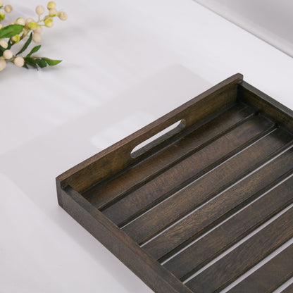 WOOD CURLS rectangular mango wood serving tray with a dark finish and cutout handles on a white surface.