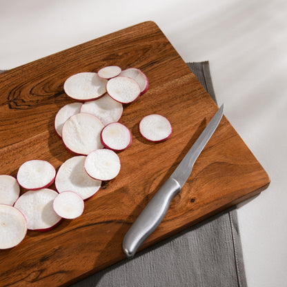 WOOD CURLS rectangular wooden chopping board with sliced radishes and a stainless steel knife on a grey placemat