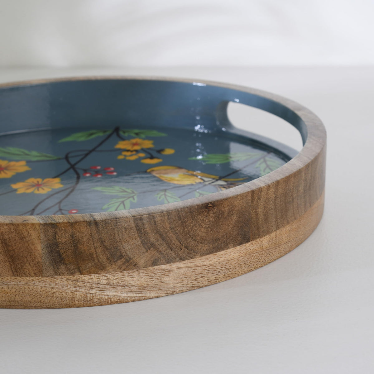 WOOD CURLS round mango wood serving tray with hand-painted blue background, yellow birds, and floral garden design.
