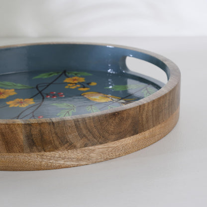 WOOD CURLS round mango wood serving tray with hand-painted blue background, yellow birds, and floral garden design.