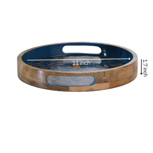 WOOD CURLS round mango wood serving tray with navy blue base, copper leaf motifs, and integrated handle cutouts.