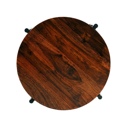 WOOD CURLS Serenity round coffee table featuring a natural grain Sheesham wood top and sleek black metal legs