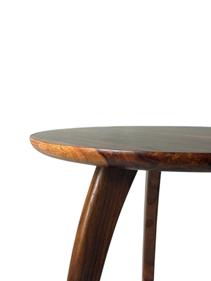 WOOD CURLS round Sheesham wood end table with a rich natural grain finish, showing a close-up of the tabletop and leg.