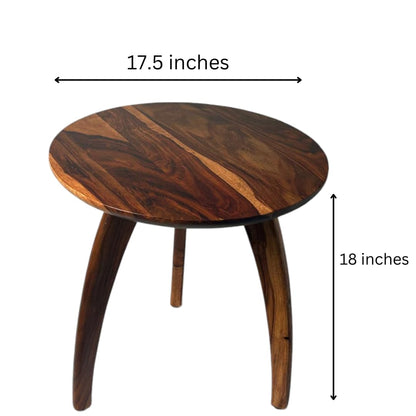 WOOD CURLS round Sheesham wood end table with a natural grain finish and three sturdy legs, 18 inches high.