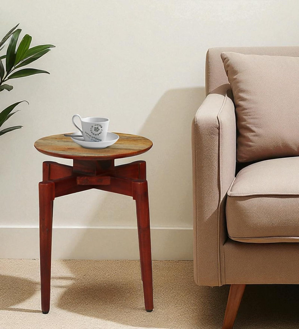 WOOD CURLS round solid wood end table with a coffee cup, placed beside a beige sofa in a modern living room.