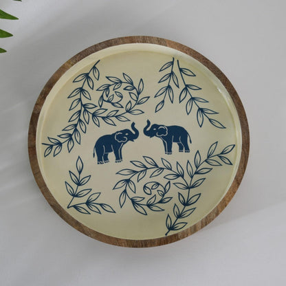 WOOD CURLS round wooden serving tray with hand-painted blue elephant and leaf motifs on a cream background