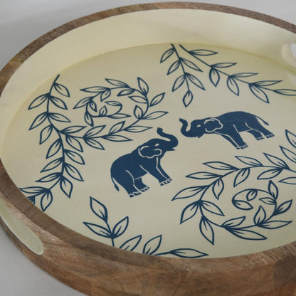 WOOD CURLS round wooden serving tray with hand-painted blue elephant and leaf motifs on a cream background