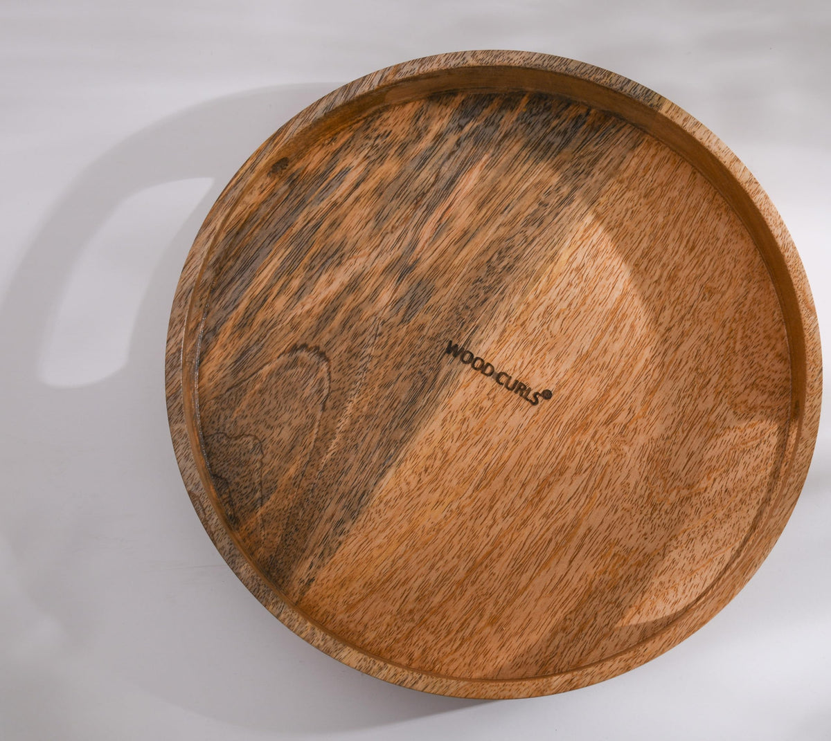 WOOD CURLS round wooden serving tray with a natural brown finish and visible wood grain on a white background