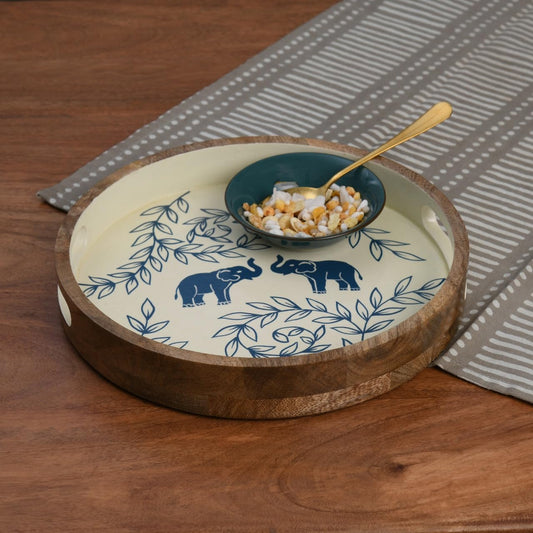 WOOD CURLS round wooden serving tray with hand-painted blue elephant and leaf motifs on a cream background