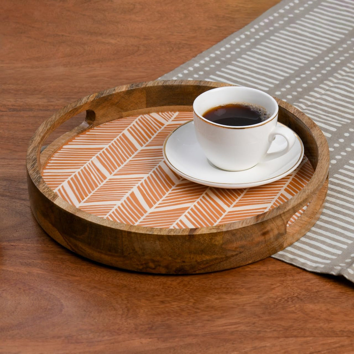 WOOD CURLS round wooden serving tray with a peach geometric herringbone enamel base holding a white coffee cup