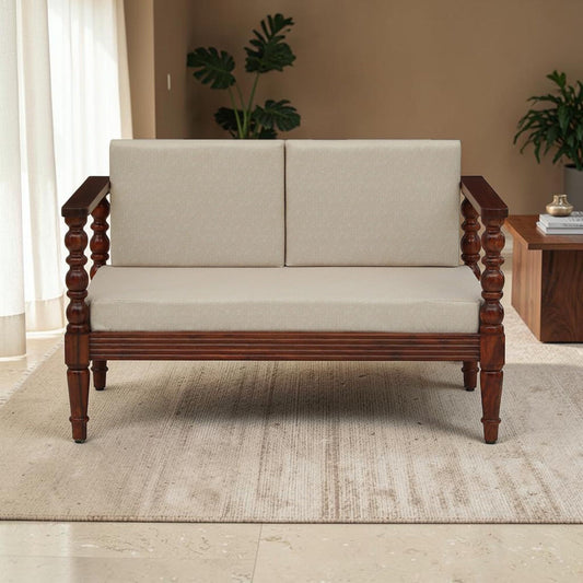 WOOD CURLS Rowan 2 seater sofa in solid Sheesham wood with a walnut finish and plush beige upholstered cushions.