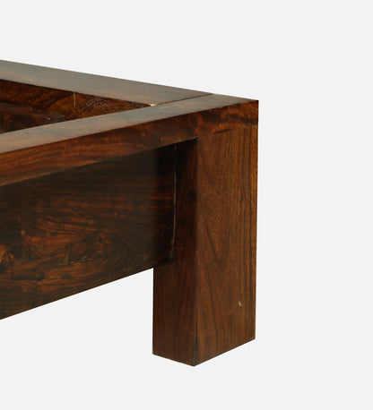 Close-up of the solid Sheesham wood frame corner on a WOOD CURLS king size bed with a natural dark wood grain finish.