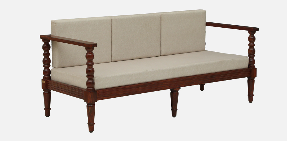 WOOD CURLS Auburn three seater sofa featuring a solid Sheesham wood frame with carved arms and beige fabric cushions.