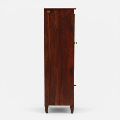 WOOD CURLS tall Sheesham wood bookcase in honey oak finish, side view showing solid wood grain and tapered legs.