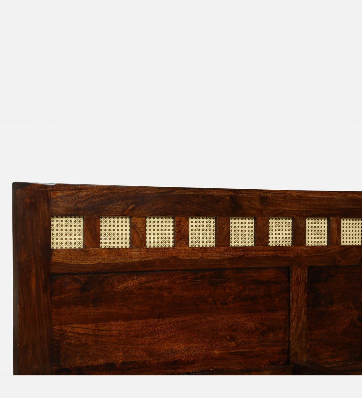 WOOD CURLS Aranya king size bed headboard featuring solid Sheesham wood frame and decorative cane panel inserts.