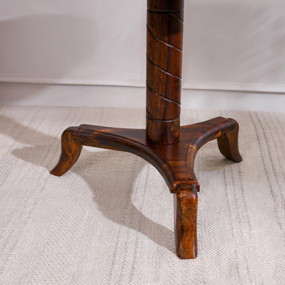 WOOD CURLS round end table base featuring a carved spiral pedestal and three curved legs in natural Sheesham wood.