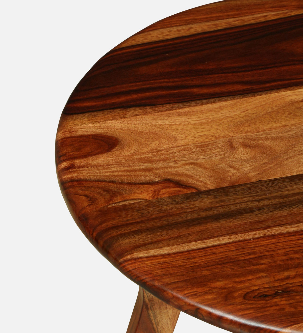 WOOD CURLS round coffee table in solid Sheesham wood with a natural finish showing detailed wood grain texture.