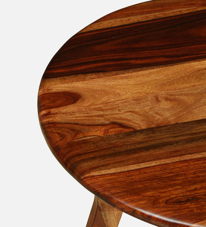 WOOD CURLS round coffee table in solid Sheesham wood with a natural finish showing detailed wood grain texture.