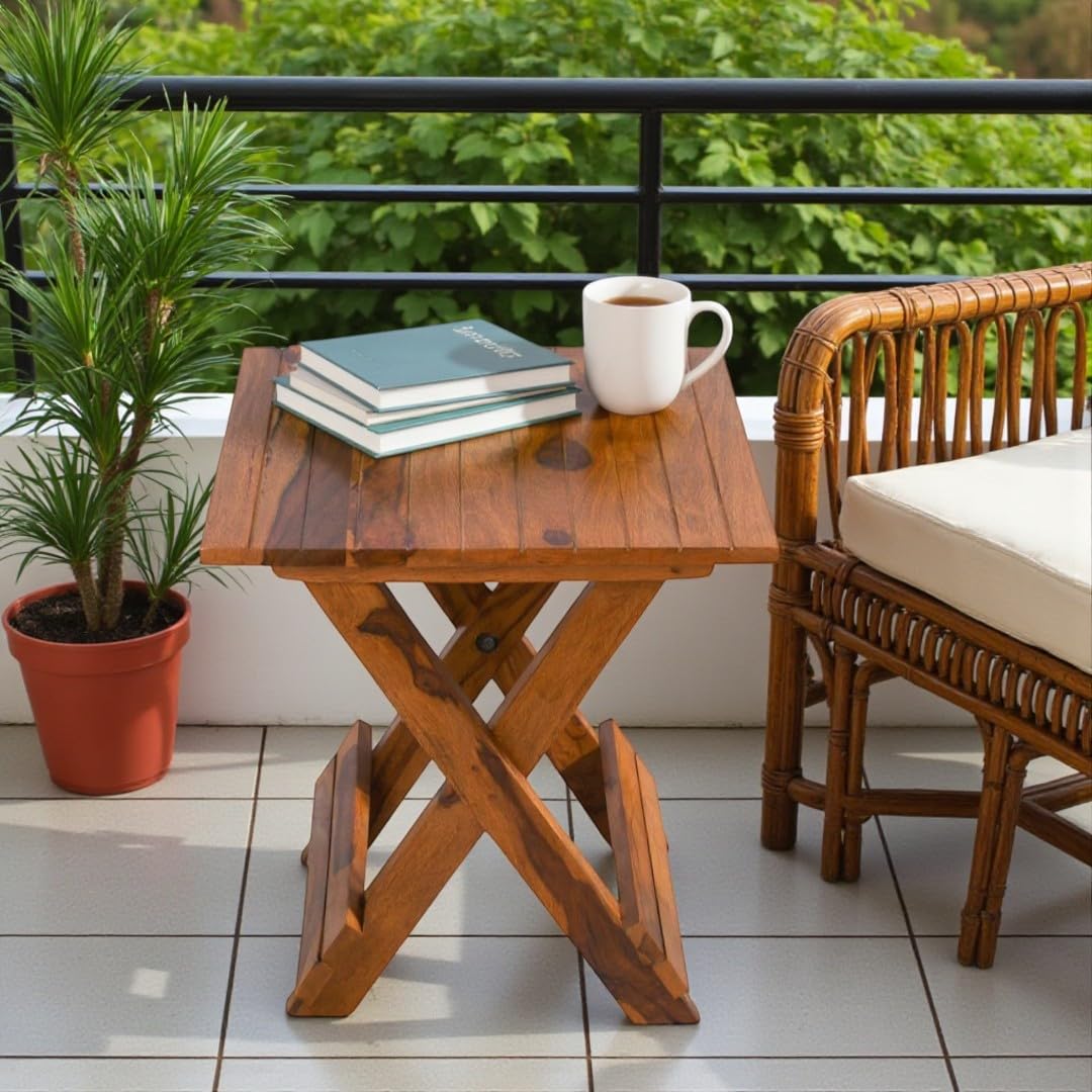 WOOD CURLS Nova square Sheesham wood coffee table with natural finish, styled on a balcony with books and a mug.
