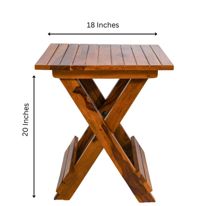 WOOD CURLS Nova square coffee table in natural Sheesham wood with a folding X-frame base and slatted tabletop.