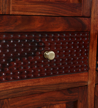WOOD CURLS Elyssian wardrobe drawer with textured carved wood pattern and round brass knob in honey oak finish.