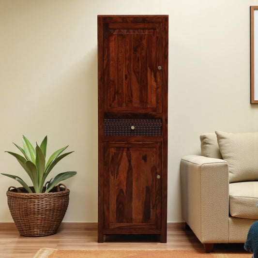 WOOD CURLS Elyssian one-door wardrobe in solid Sheesham wood with a honey oak finish and carved drawer detail.