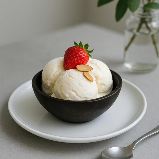 WOOD CURLS small dark brown mango wood serving bowl filled with vanilla ice cream topped with a fresh strawberry