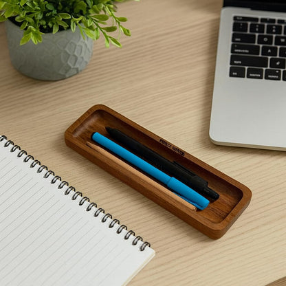 WOOD CURLS minimalist solid acacia wood desk organizer tray holding pens on a wooden office desk next to a notebook