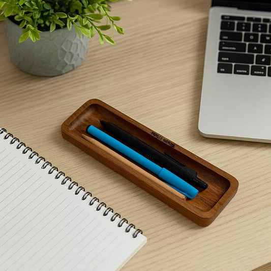 WOOD CURLS minimalist solid acacia wood desk organizer tray holding pens on a wooden office desk next to a notebook