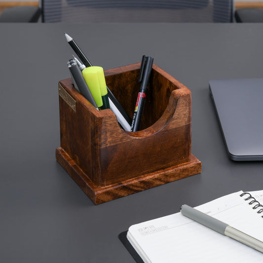 WOOD CURLS solid wood pencil holder on a dark desk with stationery, featuring a minimalist square design.