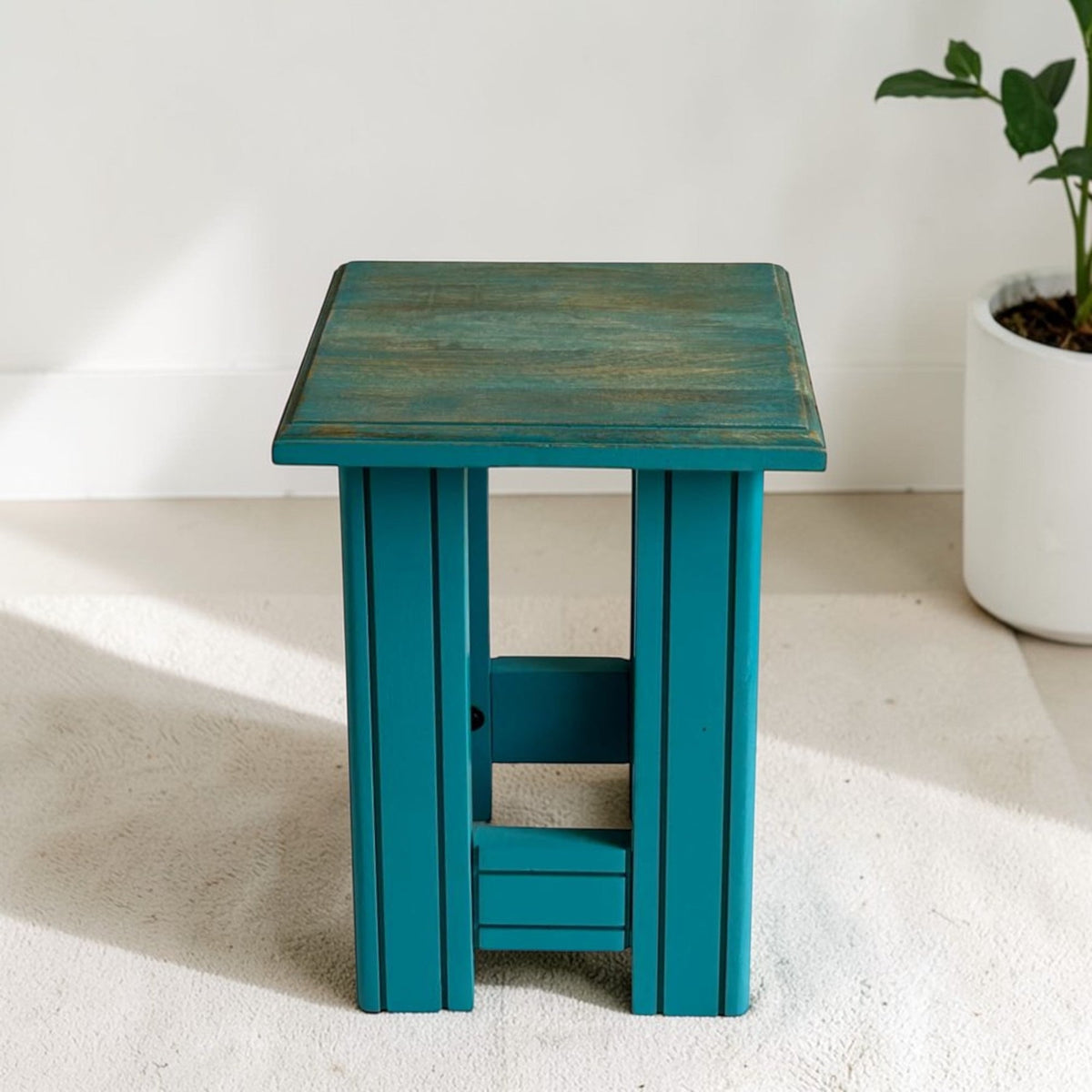 WOOD CURLS rustic solid wood end table in teal with a distressed wood grain top, serving as a versatile side stool.