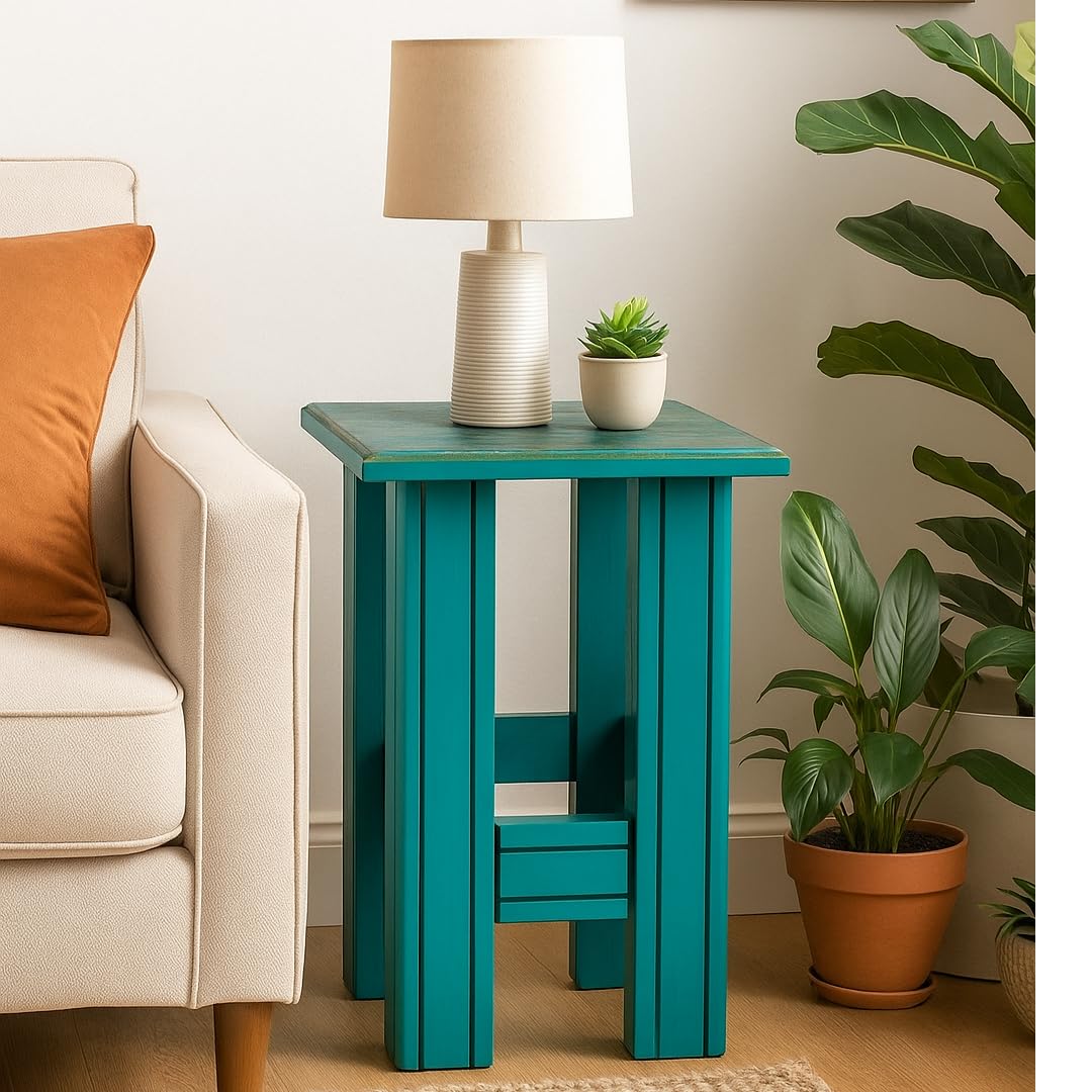 WOOD CURLS teal solid wood end table with a square top and sturdy legs, styled as a side table next to a sofa.