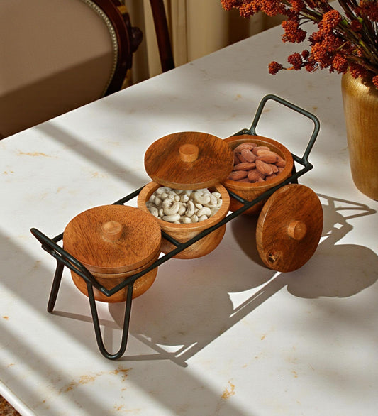 WOOD CURLS set of three handcrafted wooden bowls with lids and a black metal stand for serving snacks on a table.